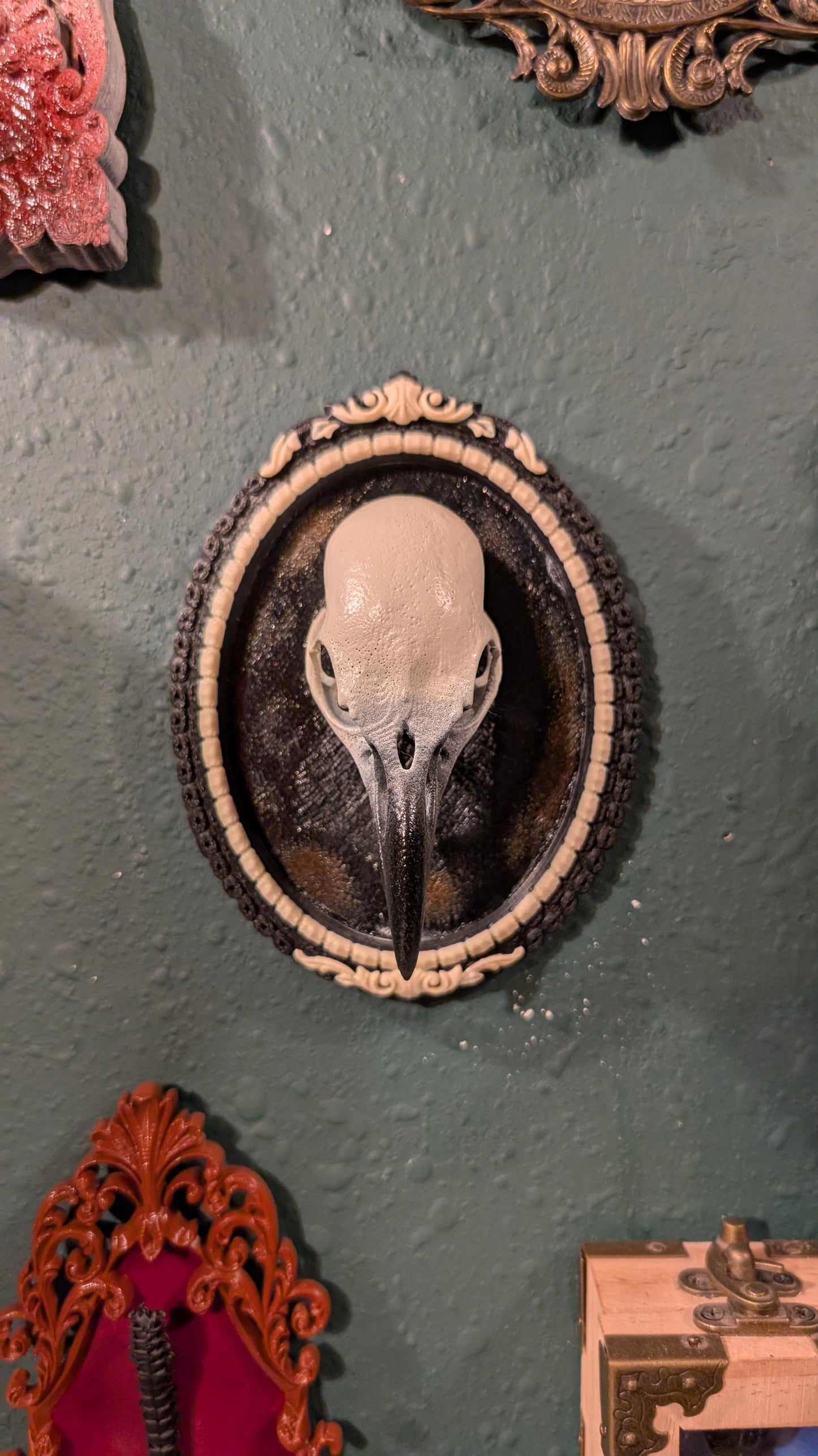 Raven skull replica in Gothic ornate frame